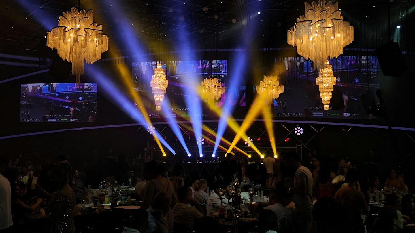 Guests seated at round tables during a corporate event hall.
